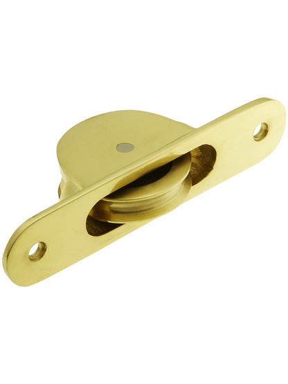 Cast Brass Radius End Sash Pulley With 1 3/4 inch Wheel in Polished Brass.